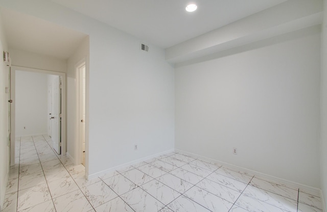 1818 Augusta Dr Unit 3, Houston, TX 77057 - unfurnished room featuring light marble finish floors, baseboards, and recessed lighting