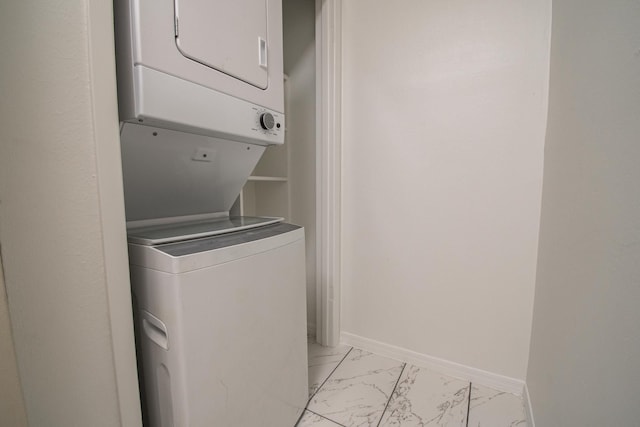1818 Augusta Dr Unit 3, Houston, TX 77057 - laundry room featuring stacked washer / dryer, light marble finish flooring, and baseboards