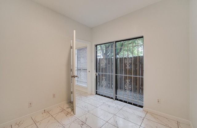 1818 Augusta Dr Unit 3, Houston, TX 77057 - empty room with marble look tile flooring and baseboards