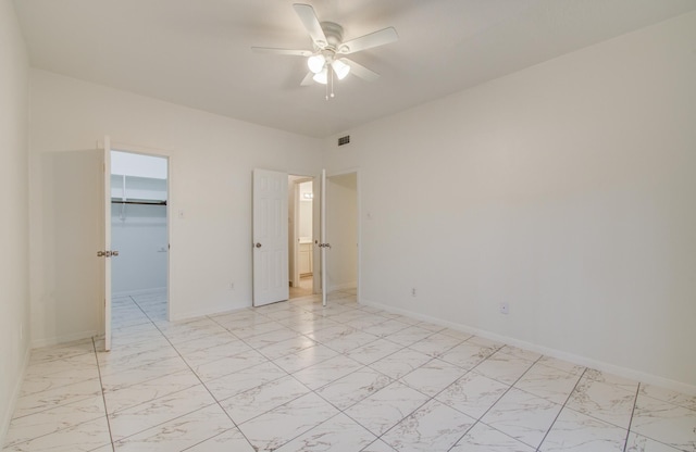 1818 Augusta Dr Unit 3, Houston, TX 77057 - unfurnished bedroom with light marble finish flooring, a spacious closet, a ceiling fan, and a closet