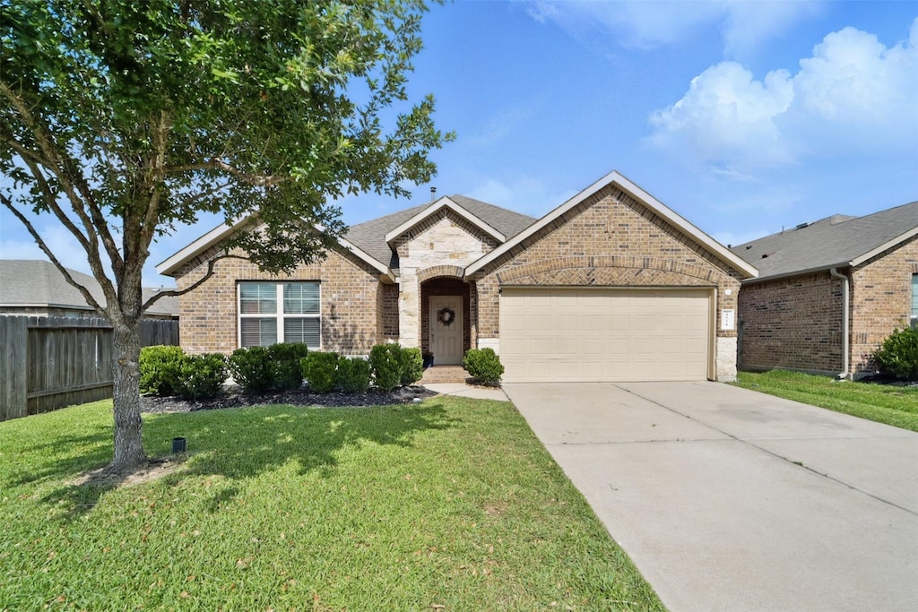 4534 Capella Riviera Dr, Katy, TX 77493 - french country home with brick siding, an attached garage, and driveway