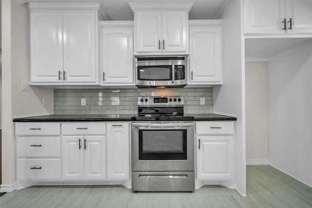 15905 Lakeview Dr, Jersey Village, TX 77040 - kitchen with stainless steel appliances, tasteful backsplash, white cabinetry, light wood-style flooring, and crown molding