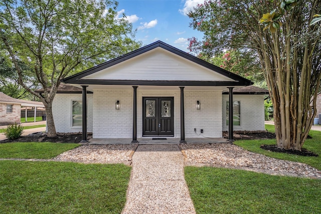 15905 Lakeview Dr, Jersey Village, TX 77040 - view of front of house featuring a front lawn, brick siding, and covered porch