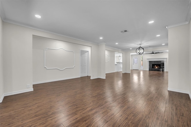 15905 Lakeview Dr, Jersey Village, TX 77040 - unfurnished living room with dark wood-type flooring, recessed lighting, crown molding, a tiled fireplace, and a chandelier