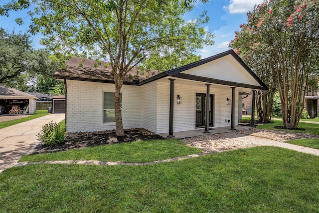 15905 Lakeview Dr, Jersey Village, TX 77040 - view of front of home with brick siding, a front lawn, and covered porch
