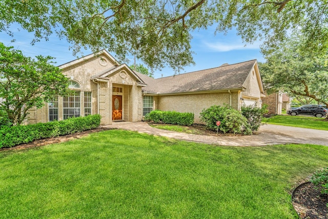 1722 Brook Grove Dr, Katy, TX 77450 - ranch-style home featuring brick siding, a front yard, a garage, roof with shingles, and concrete driveway