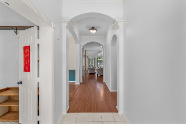 1722 Brook Grove Dr, Katy, TX 77450 - hallway with baseboards, light tile patterned flooring, arched walkways, ornate columns, and crown molding