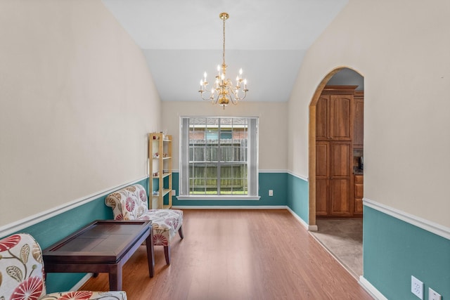 1722 Brook Grove Dr, Katy, TX 77450 - sitting room with wood finished floors, a chandelier, vaulted ceiling, arched walkways, and baseboards