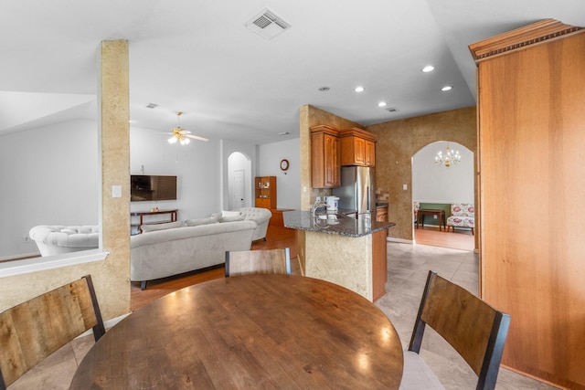 1722 Brook Grove Dr, Katy, TX 77450 - dining room featuring arched walkways, recessed lighting, a chandelier, ceiling fan, and light tile patterned floors