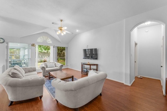 1722 Brook Grove Dr, Katy, TX 77450 - living area with arched walkways, wood finished floors, vaulted ceiling, ceiling fan, and baseboards