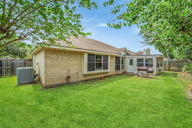 1722 Brook Grove Dr, Katy, TX 77450 - back of property with cooling unit, brick siding, a chimney, a sunroom, and a shingled roof