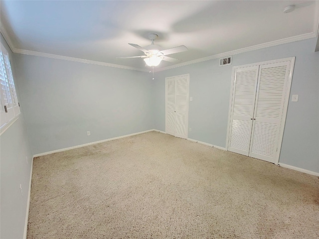 7900 Westheimer Rd Unit 255, Houston, TX 77063 - unfurnished bedroom featuring two closets, ornamental molding, baseboards, ceiling fan, and carpet floors