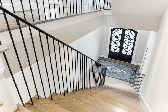 4613 Maple St, Bellaire, TX 77401 - entrance foyer with wood finished floors, stairs, baseboards, and a towering ceiling