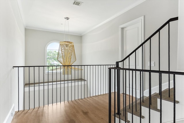 4613 Maple St, Bellaire, TX 77401 - staircase featuring wood finished floors, crown molding, and a chandelier