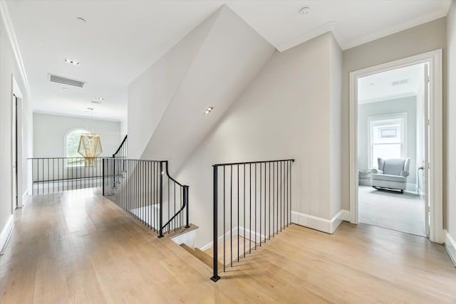 4613 Maple St, Bellaire, TX 77401 - hall with an upstairs landing, wood finished floors, ornamental molding, and baseboards