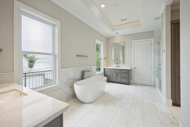 4613 Maple St, Bellaire, TX 77401 - full bath with two vanities, a stall shower, tile walls, crown molding, and a freestanding bath