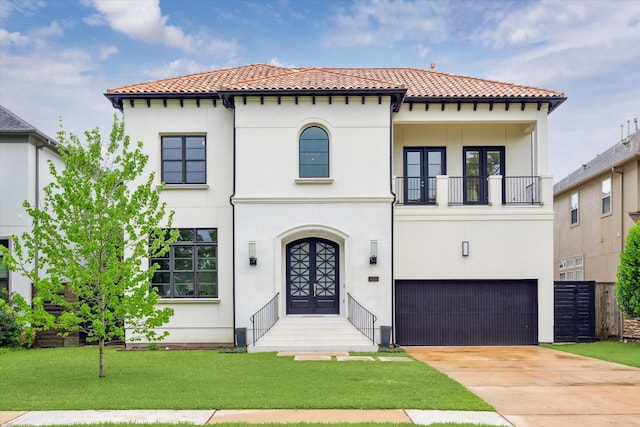 4613 Maple St, Bellaire, TX 77401 - mediterranean / spanish-style home featuring a balcony, a tiled roof, a garage, and french doors