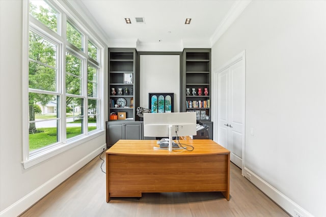 4613 Maple St, Bellaire, TX 77401 - office area featuring ornamental molding, light wood-style flooring, plenty of natural light, and baseboards