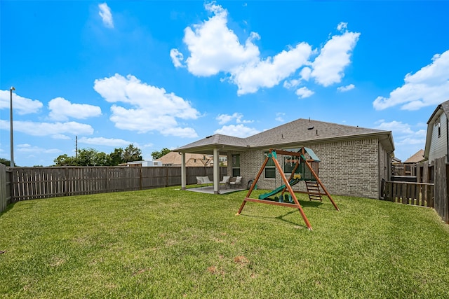 19443 Pacers Gait Ln, Tomball, TX 77377 - rear view of house with brick siding, a patio area, and a playground