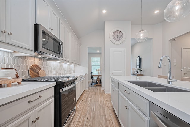19443 Pacers Gait Ln, Tomball, TX 77377 - kitchen with stainless steel appliances, a sink, decorative backsplash, light countertops, and lofted ceiling