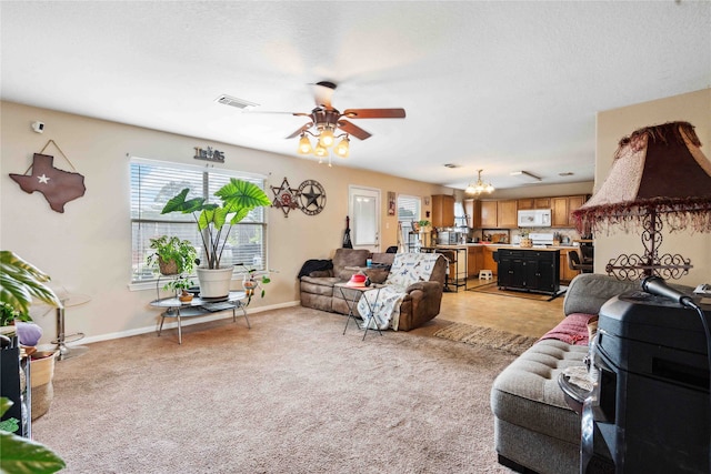 24235 Stargazer Pt, Spring, TX 77373 - living area with a ceiling fan, light carpet, baseboards, and a chandelier
