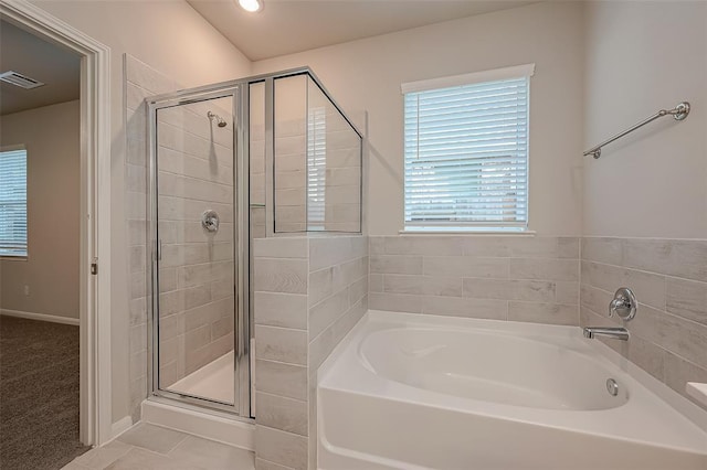 27335 Axis Deer Trl, Magnolia, TX 77354 - bathroom featuring a bath, a shower stall, and tile patterned floors