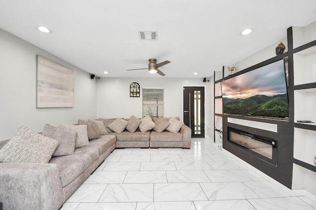 8707 Tartan Walk Ln, Houston, TX 77075 - living room featuring recessed lighting, light marble finish flooring, a glass covered fireplace, and ceiling fan