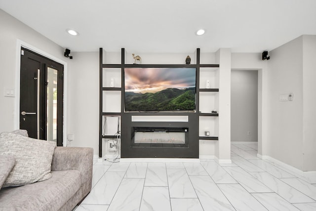 8707 Tartan Walk Ln, Houston, TX 77075 - living area featuring built in features, a glass covered fireplace, marble finish flooring, recessed lighting, and baseboards