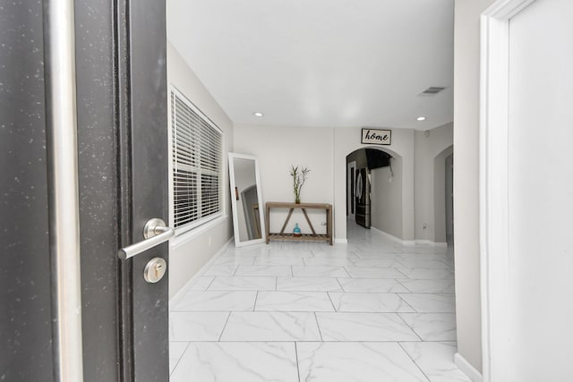 8707 Tartan Walk Ln, Houston, TX 77075 - hallway with arched walkways, marble finish floors, recessed lighting, and baseboards