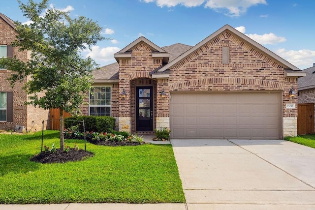 15210 Monal Trie Dr, Humble, TX 77346 - view of front of house with brick siding, a front lawn, concrete driveway, a garage, and a shingled roof