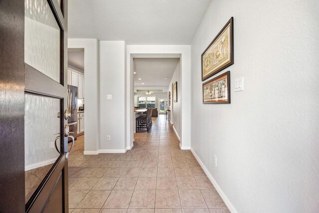 15210 Monal Trie Dr, Humble, TX 77346 - hall featuring light tile patterned floors and baseboards