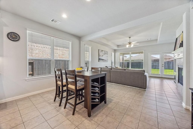 15210 Monal Trie Dr, Humble, TX 77346 - dining area featuring light tile patterned flooring, a tray ceiling, baseboards, a ceiling fan, and recessed lighting
