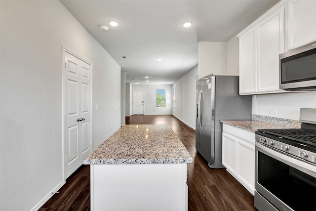 25919 Llano Knoll Ln, Katy, TX 77493 - kitchen with stainless steel appliances, dark wood-style floors, a center island, white cabinetry, and recessed lighting