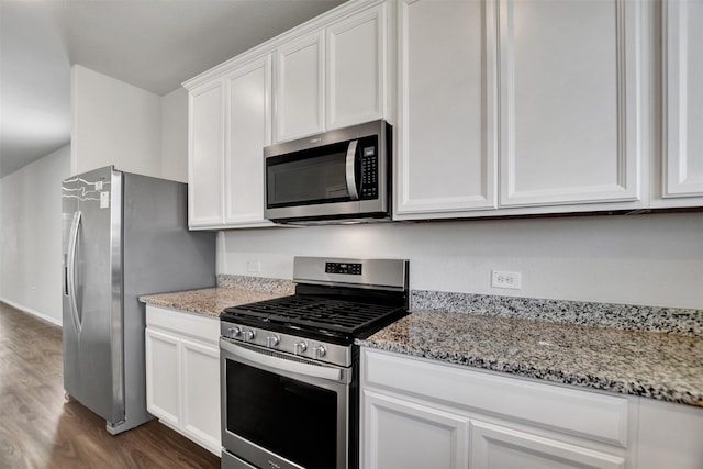 25919 Llano Knoll Ln, Katy, TX 77493 - kitchen with stainless steel appliances, dark wood-style floors, white cabinets, and light stone countertops