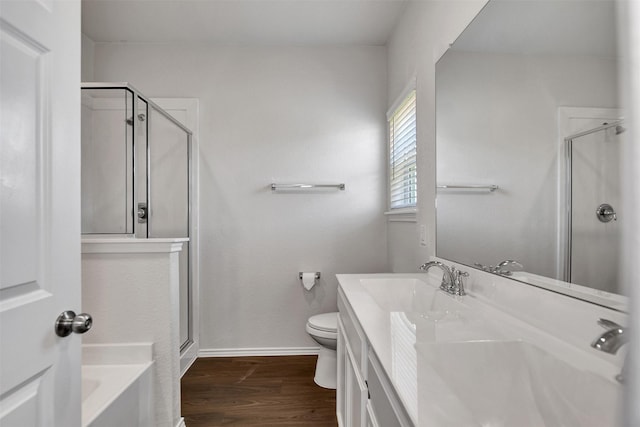 25919 Llano Knoll Ln, Katy, TX 77493 - bathroom featuring a shower stall, vanity, wood finished floors, and toilet