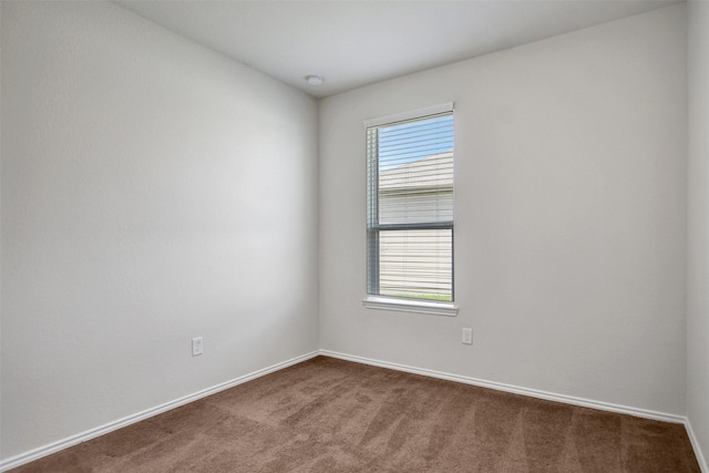 25919 Llano Knoll Ln, Katy, TX 77493 - unfurnished room featuring dark carpet, baseboards, and a smoke detector