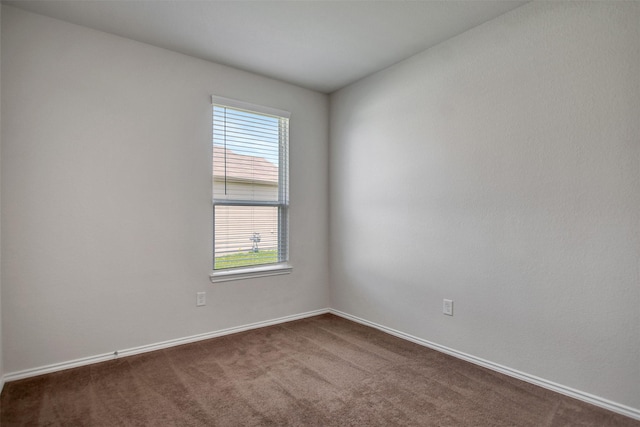 25919 Llano Knoll Ln, Katy, TX 77493 - spare room featuring baseboards and dark carpet