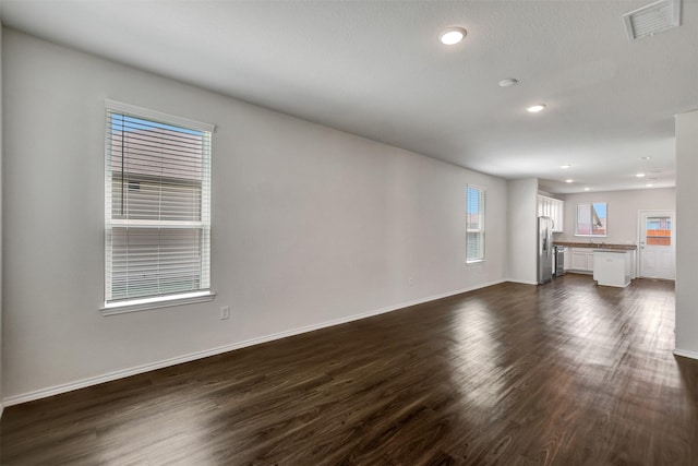 25919 Llano Knoll Ln, Katy, TX 77493 - unfurnished living room featuring dark wood-style floors, recessed lighting, and baseboards