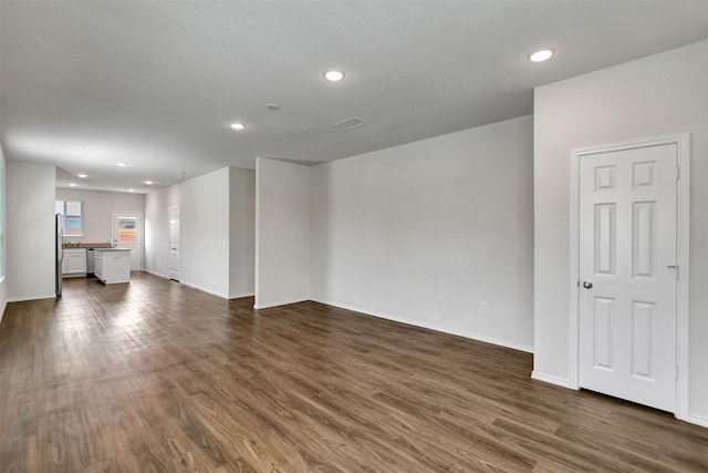 25919 Llano Knoll Ln, Katy, TX 77493 - unfurnished living room with dark wood finished floors, baseboards, and recessed lighting