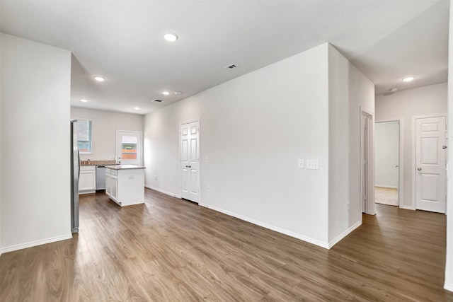 25919 Llano Knoll Ln, Katy, TX 77493 - unfurnished living room featuring wood finished floors, recessed lighting, and baseboards