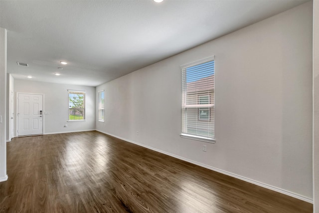 25919 Llano Knoll Ln, Katy, TX 77493 - unfurnished room featuring plenty of natural light, baseboards, dark wood-style floors, and recessed lighting