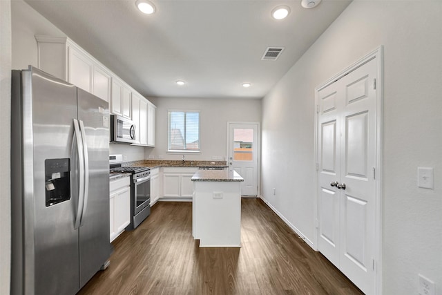 25919 Llano Knoll Ln, Katy, TX 77493 - kitchen with stainless steel appliances, white cabinetry, a sink, dark wood-type flooring, and recessed lighting