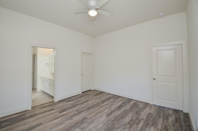 9414 Kerrwood Ln Unit B, Houston, TX 77080 - unfurnished bedroom featuring light wood-style flooring, baseboards, connected bathroom, and a ceiling fan