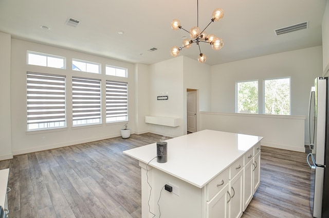 9414 Kerrwood Ln Unit B, Houston, TX 77080 - kitchen with freestanding refrigerator, a chandelier, a center island, light wood-style floors, and light countertops