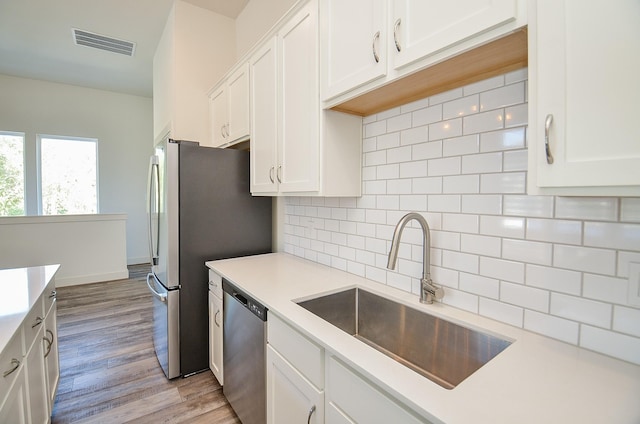 9414 Kerrwood Ln Unit B, Houston, TX 77080 - kitchen with appliances with stainless steel finishes, a sink, backsplash, and light countertops