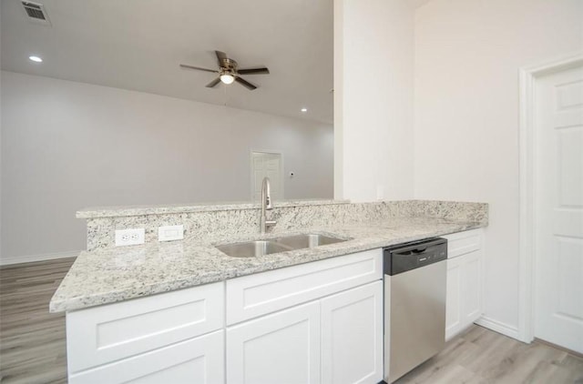 2352 Cedar Place Dr, Conroe, TX 77306 - kitchen featuring dishwasher, a sink, light wood-style flooring, ceiling fan, and light stone counters