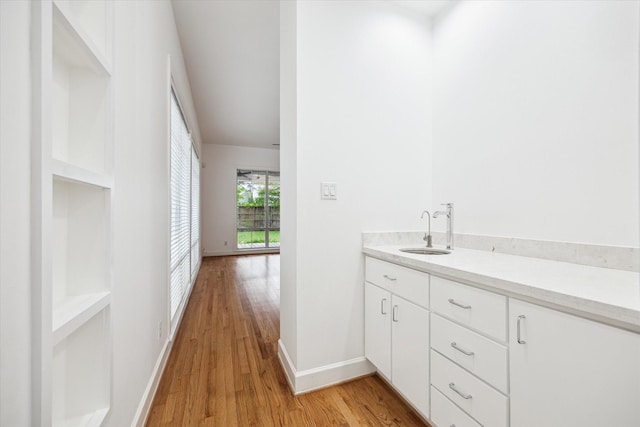 4521 Palmetto St, Bellaire, TX 77401 - bathroom featuring wood finished floors, baseboards, and vanity