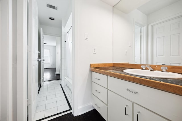 4521 Palmetto St, Bellaire, TX 77401 - bathroom with vanity, tile patterned flooring, and baseboards