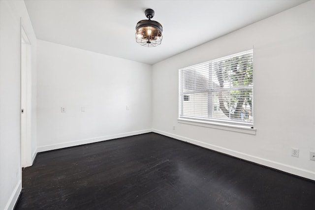 4521 Palmetto St, Bellaire, TX 77401 - spare room with baseboards and dark wood-style floors