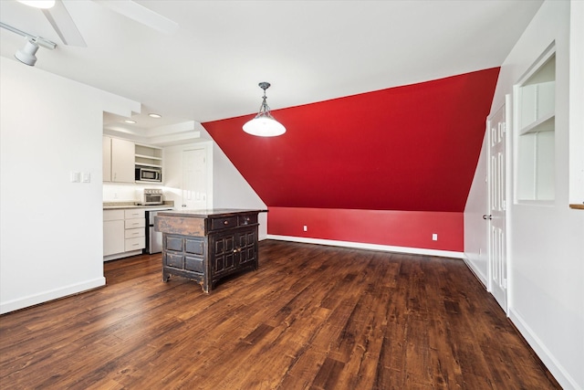 4521 Palmetto St, Bellaire, TX 77401 - kitchen featuring stainless steel microwave, dark wood-style floors, white cabinets, a ceiling fan, and pendant lighting